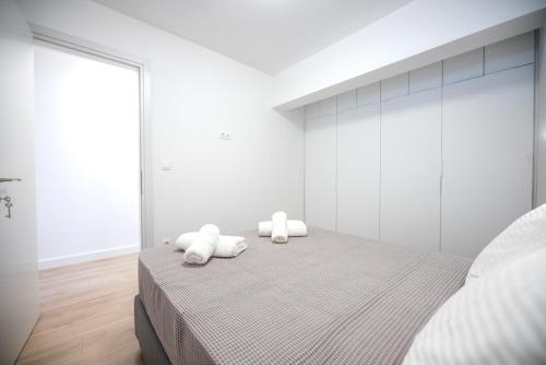 a bedroom with a bed with two towels on it at LASARI comfort living in Thessaloniki