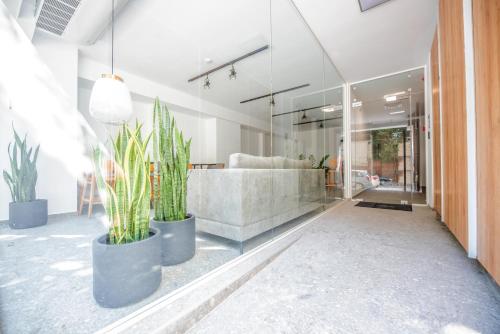 a lobby with potted plants and a couch at LASARI comfort living in Thessaloniki