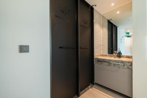 a bathroom with two sinks and a large mirror at Hotel GITE in Siheung