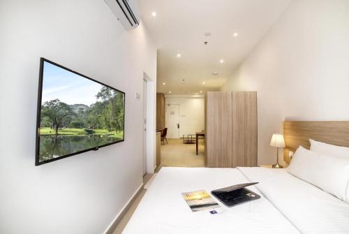 a bedroom with a large window on the wall at The Signature Serviced Suites Puchong in Puchong