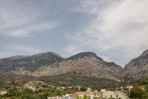 a view of a mountain range with houses and buildings at Froso's Home in Zarós