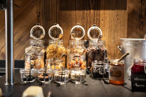 a bunch of jars of food sitting on a counter at Hotel Pongauerhof in Flachau