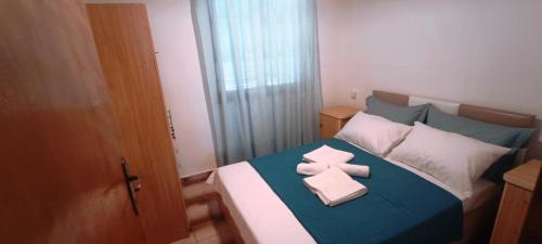 a bedroom with a bed with two folded towels on it at Villas Kiriaki in Kallirákhi