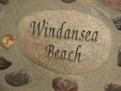 a rock with the words windblown beach written on it at The Shoal Hotel La Jolla Beach in San Diego