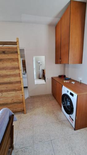a kitchen with a washing machine and a staircase at Beachfront 2-bedroom apartment in Salamís