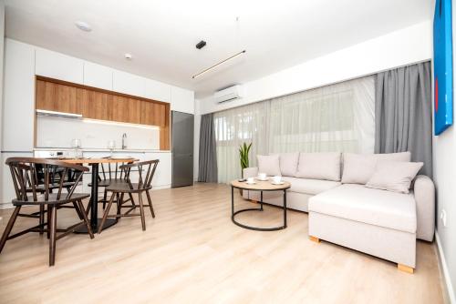 a living room with a couch and a table at LASARI comfort living in Thessaloniki