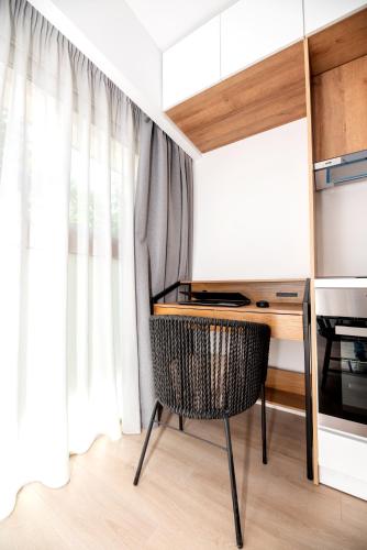 a room with a desk and a chair in front of a window at LASARI comfort living in Thessaloniki