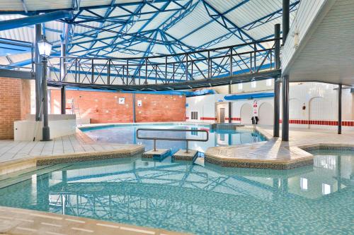a large swimming pool with water in a building at Solway Holiday Park in Silloth
