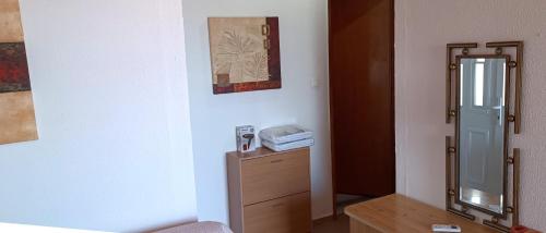 a room with a dresser and a mirror and a desk at Villas Kiriaki in Kallirákhi