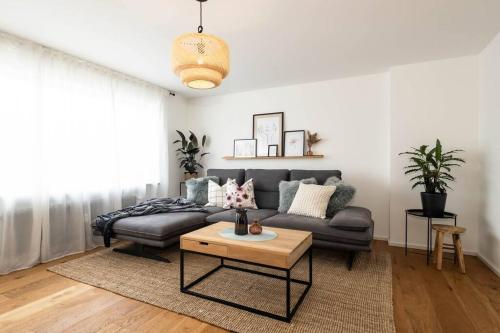 a living room with a couch and a coffee table at Luxury Apartment on the Rhein in Busingen am Hochrhein