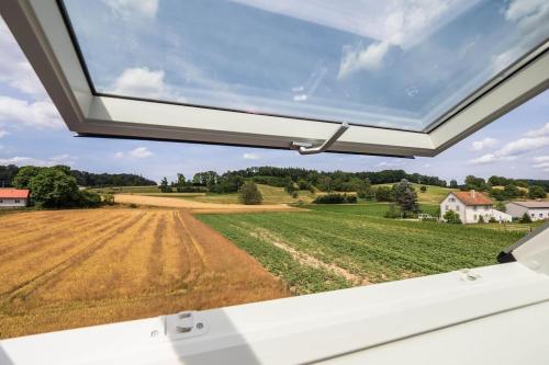 a view from the back window of a rv looking at a field at Luxury Apartment on the Rhein in Busingen am Hochrhein
