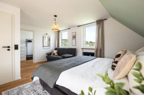 a bedroom with a large bed and a couch at Luxury Apartment on the Rhein in Busingen am Hochrhein