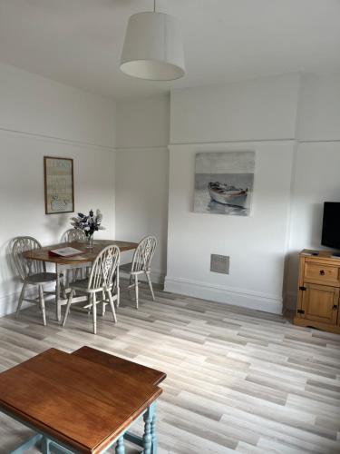 a dining room with a table and chairs at Flat Beside the sea in Southend-on-Sea
