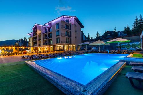 a large swimming pool in front of a building at Gold Palace Bukovel in Bukovel
