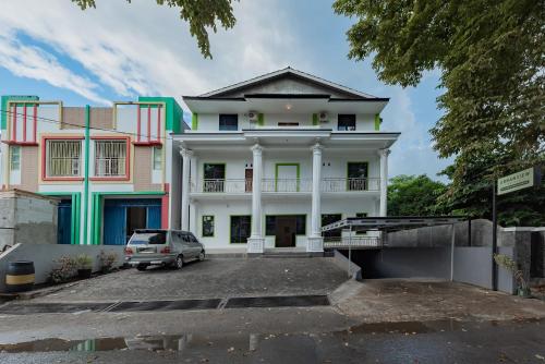 a car parked in front of a building at Urbanview Hotel 99 Syariah Banjarbaru by RedDoorz in Martapura