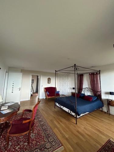 a bedroom with a bed and a living room at chambre romantique dans le château de la Bouchatte in Chazemais