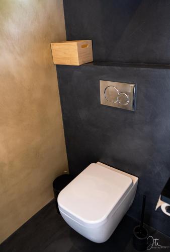 a bathroom with a toilet with two rings on the wall at Apartman Marisari in Lastovo