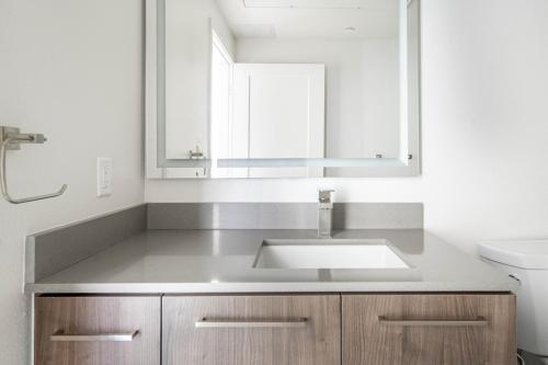 a bathroom with a sink and a mirror at Mountain View Studio w Gym WD nr 101 SFO-673 in Los Altos