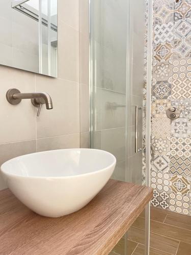 a bathroom with a white bowl sink and a shower at A Casa dei Miei in Otranto