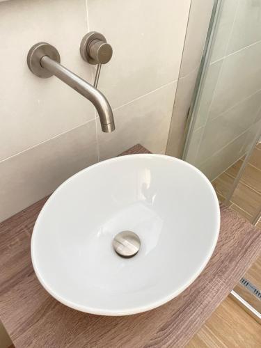 a white toilet in a bathroom with a sink at A Casa dei Miei in Otranto