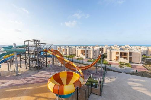 a water park with a slide and a roller coaster at Gewan Resort New Alamein in El Alamein