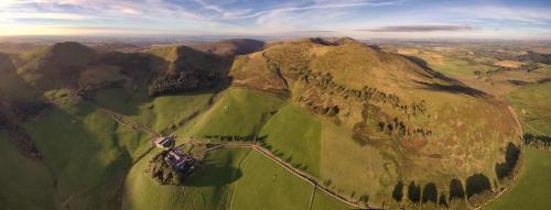 an aerial view of a mountain with a road on it at Eastside Steading - Family barn in the Pentland Hills, Edinburgh in Penicuik