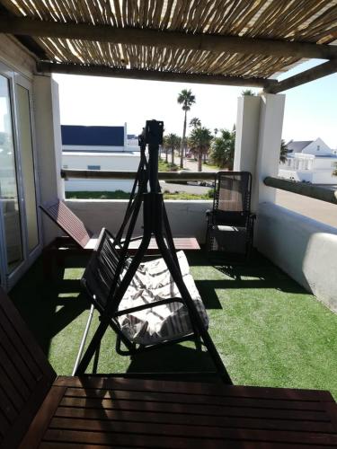 a camera on a hammock on a porch at The Tides Holiday Home in St Helena Bay