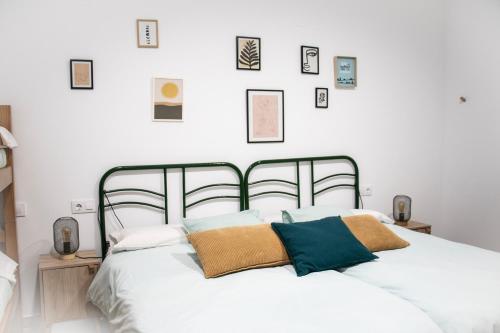 a bedroom with a white bed with pillows on it at Casas rurales La Carrasca in Ossa de Montiel