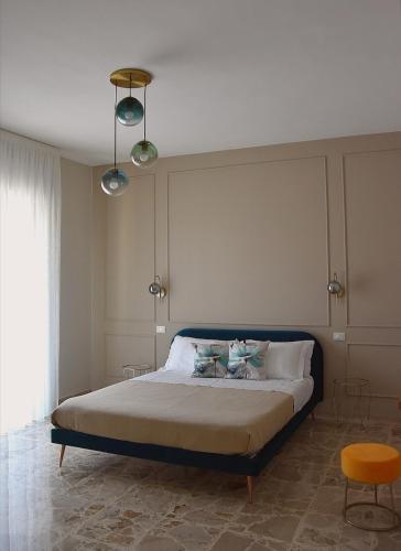 a bedroom with a bed with two pillows on it at Russo Apartment in Termoli