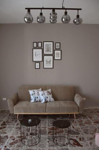 a living room with a couch and two tables at Russo Apartment in Termoli