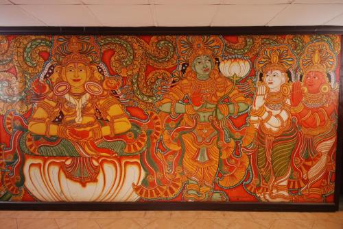 a large painting of deities on a wall at The Raviz Kadavu, Kozhikode in Kozhikode