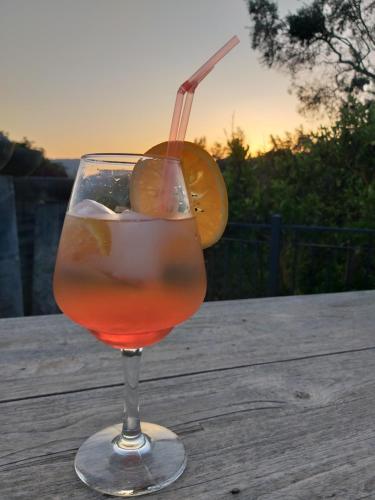a drink in a glass sitting on a wooden table at El Violin Experiencia Adults only in Melegis