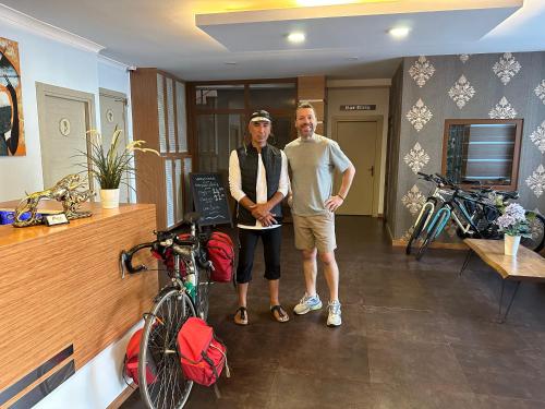 two men are standing in a room with bikes at Line Suite Hotel in Kırklareli