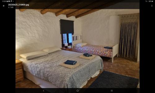 a bedroom with two beds with towels on them at Lemontree house set in the countryside. in Água de Tábuas