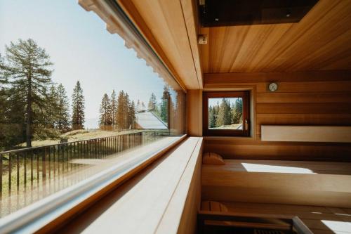 a room with a large window with a view at Knappenhütte in Villach