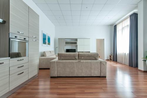 a living room with a couch and a kitchen at Suite San Biagio in Lecce