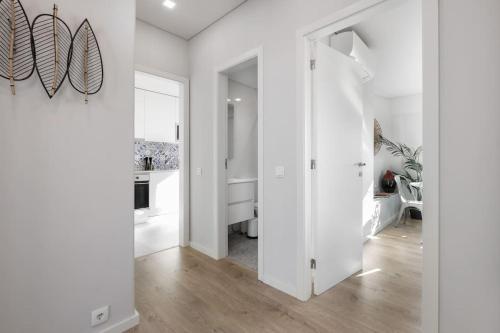 a hallway with white walls and a sliding door at Lisbon Central Apartment with Balcony in Lisbon