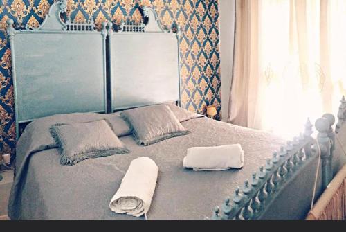a bed with two towels and two pillows on it at Gioia Chic & Economy in Gioia Tauro