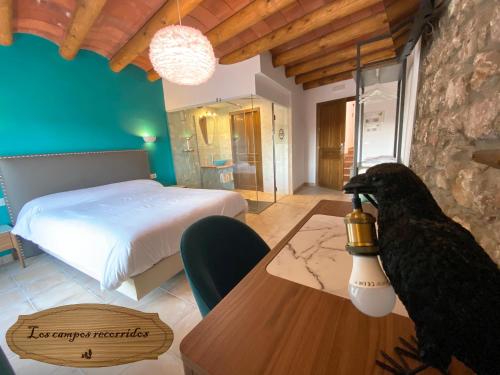 a bedroom with a bed and a bird on a table at Hotel Boutique Malanquilla Inedita in Malanquilla