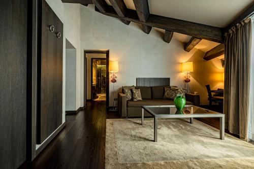 a living room with a couch and a table at Hyatt Centric Murano Venice in Murano