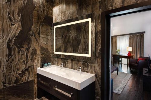 a bathroom with a sink and a mirror at Hyatt Centric Murano Venice in Murano