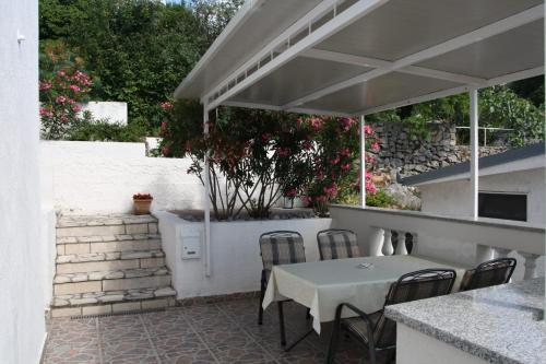 un patio con mesa y sillas bajo un dosel en Apartman Mara, en Sveti Juraj