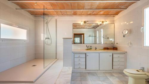 a bathroom with a shower and a sink and a toilet at Can Anadï in Sant Jordi