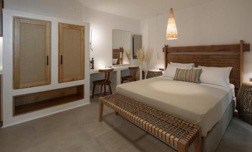 a bedroom with a large bed and a desk at "Makava Suites" Your Luxe Urban Sanctuary in Naxos Chora