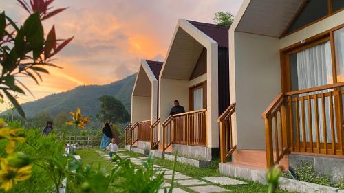 a rendering of a house with a sunset in the background at Rautani Sembalun in Sembalun Lawang