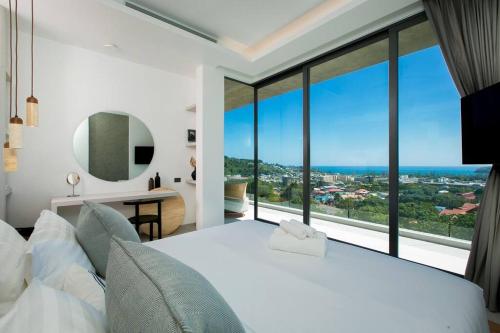 カタビーチにあるVilla Nordic Starのベッドルーム(大きな白いベッド1台、大きな窓付)