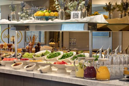 a buffet line with bowls of vegetables and fruits at Mula Hotel in Istanbul