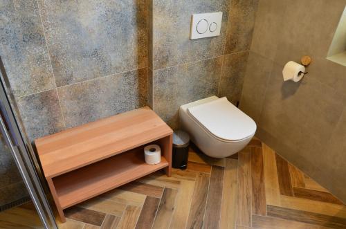 a small bathroom with a toilet and a sink at FloraVilla in Rajecké Teplice