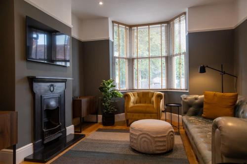 a living room with a couch and a fireplace at Clifton Villa By RentMyHouse in Hereford