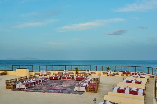 a restaurant on the beach with the ocean in the background at Dreams Beach Resort - Sharm El Sheikh in Sharm El Sheikh